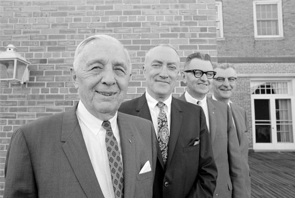 The newly-named officers of Spoo and Son Men's store. From left are Erwin M. Spoo, founder and chairman of the board; E. Wesley Holmquist, president; Eric M. Lutterman, vice-president; and William J. Dyhr, treasurer.