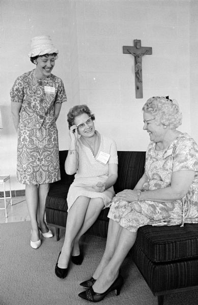 Three women confering at the convention of the Madison Diocesan Council of Catholic Women at Edgewood College. In this portrait are Mrs. Fred Segebrecht, Barneveld; Mrs. L.C. Smith, Lancaster; and Mrs. John R. McDonald, Black River Falls.