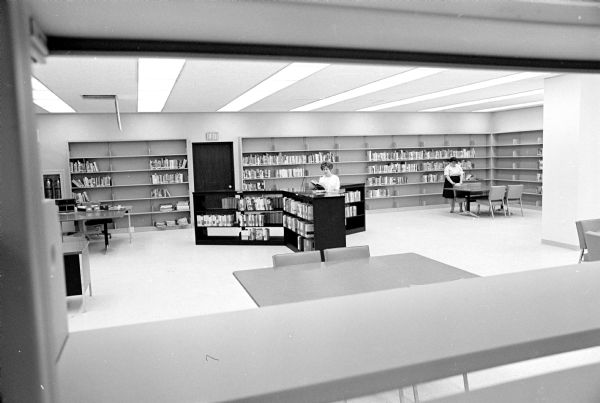 The young adult section of the new Madison Public Library at 201 West Mifflin Street. Librarians Virginia Stavn and Marilee Foglesong are working in the background. One of a series of photographs showing rooms at the new building prior to an upcoming open house and the opening of the library.