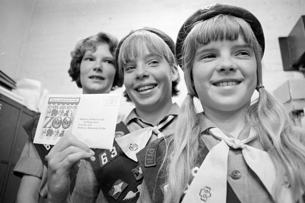 Girl Scouts from Troop 638 donate $21.63 from cookie sales to the Henry Vilas Children's Zoo instead of using the funds for a party. Troop members shown (L-R) are: Jane Bush, 317 Kensington Drive; Adelle Forsberg, 33 Harbor Drive; and Kathy McLean, 200 Lakewood Boulevard.
