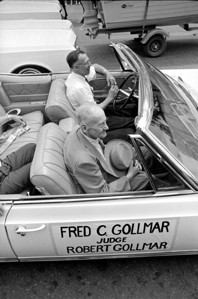 Fred C. Gollmar, 93, doffing his hat while riding in the annual circus celebration parade in Baraboo. He is a founder of the Gollmar Brothers Circus along with his four brothers. The parade was dedicated to him.