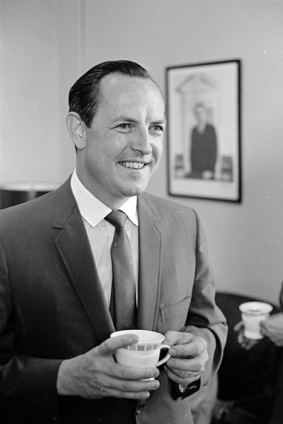 A man standing and holding a coffee cup. Edmund A. Dix was sworn in as United States attorney for the western half of Wisconsin in a brief Federal Court ceremony conducted by Judge James E. Doyle. "Nix," a former three-term Eau Claire county district attorney, was appointed to the $18,500 a year post by President Johnson.