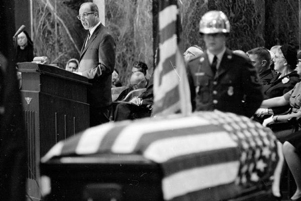 Senator Gaylord Nelson delivering a eulogy at the funeral service for former Wisconsin governor Philip F. La Follette in the Wisconsin State Capitol.