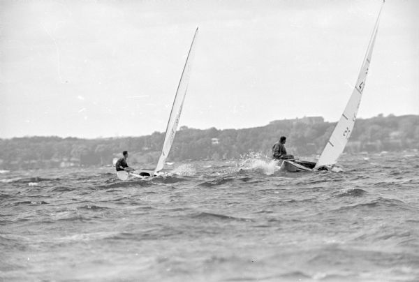 Two sailboats on the rough waters of Lake Mendota in the national Finn class sailing championship. Pete Barrett of Costa Mesa, California, formerly of Madison, has a solid lead in the competition.