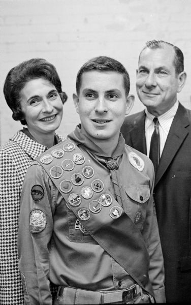 Jeffrey Levy (15), son of Mr. and Mrs. Irving Levy, 3941 Plymouth Circle, who achieved the rank of Eagle Scout, is shown with his parents. Jeffrey is a sophomore at West Senior High School and a member of Boy Scout Troop 118, sponsored by the Van Hise School PTA.