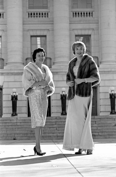 Dane County Republican Women's Club hosts a luncheon and fur style show program at the Maple Bluff County Club. Shown modeling fur jackets are (L-R) Mrs. Daniel Neviaser, 5021 LaCrosse Lane; and Mrs. James R. Graham, 710 Ottawa Trail. They are posing outdoors in front of the Wisconsin State Capitol.