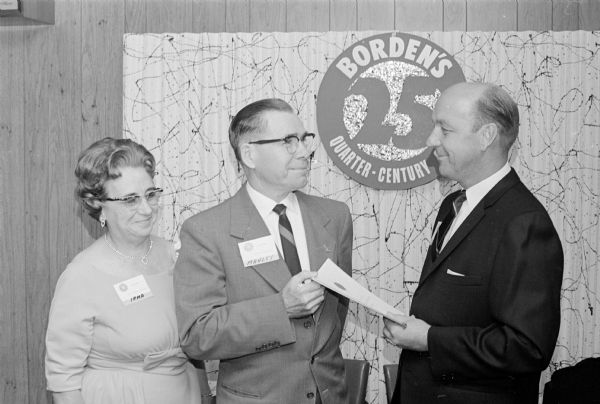 Manley R. Showers, 318 Glenway Street, is honored for forty years of service at the Madison Borden's Company. Showers began as a clerk in 1925 and retired as the cashier of the Madison division. Shown (L-R) are: Mrs. Showers, Mr. Showers, and Maynard S. Quinsland, general manager of the Madison Borden Company.