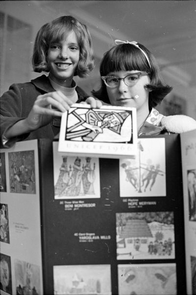 Proclaiming that UNICEF greeting cards will soon be on sale by their group are two members of Madison's 20 Y-Teen Club. Left to right, holding up a UNICEF card are Heidi Alford and Paula Bishop.