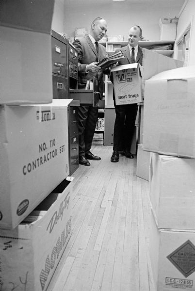 The Madison Recreation Department's sports office moves from the Community Center building to the Board of Education's Administrative Offices in the Washington School, 545 W. Dayton Street. Shown boxing files are (L-R) sports director Gene Wendland, and administrative clerk Cromer Chapman.    
