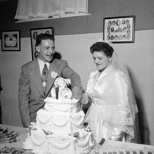 Clark Wilkinson wedding. The bride and groom are cutting the wedding cake.