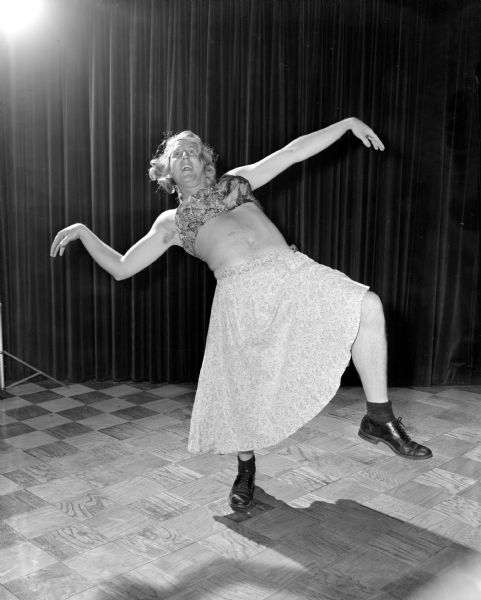 Bob Lulling (?) dressed as a woman posing as a dancer.   