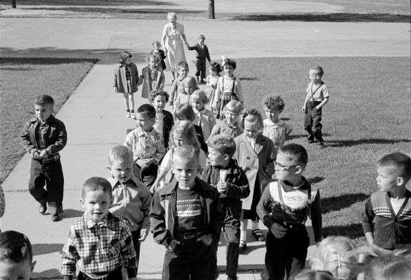 Miss McGill, Oregon, with her new kindergarten class at Marquette School, returning from a walk around the school grounds.
