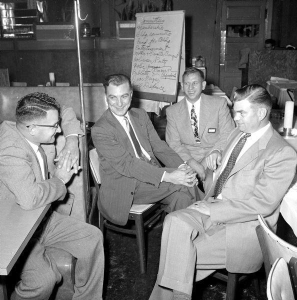 After the formal meeting of the South Side Men's Club there is time for conversation. Norman Opatt (left) draws smiles from William Dyhr (second from left), Helmuth Dintemann, and Ollie Norsetter.