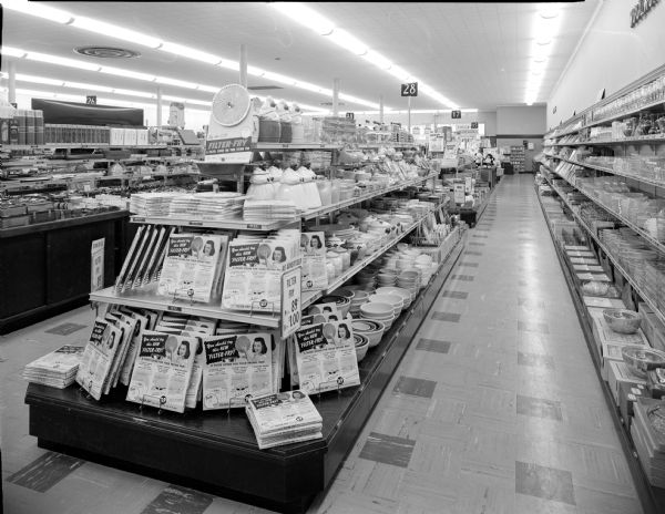 Interior of Woolworth's at the Madison East Shopping Center at 2925 East Washington Avenue. Display features boxes of Filter Fries. "You should try this new Filter Fry. A filter cover for your frying pan." Also on display are cookie jars featuring the African-American stereotype "Aunt Jemima."