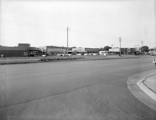 Exterior view of the Madison East Shopping Center at 2925 East Washington Avenue. Some of the stores are the Harry S. Manchester Department Store, Krogers, Rennebohm Drugstore and F.W. Woolworth's.