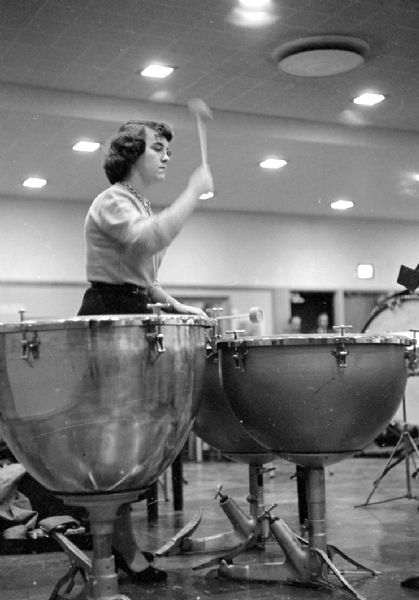 Loraine Emordeno provides tympani beats during the rehearsal of the civic symphony in Scanlan Hall.