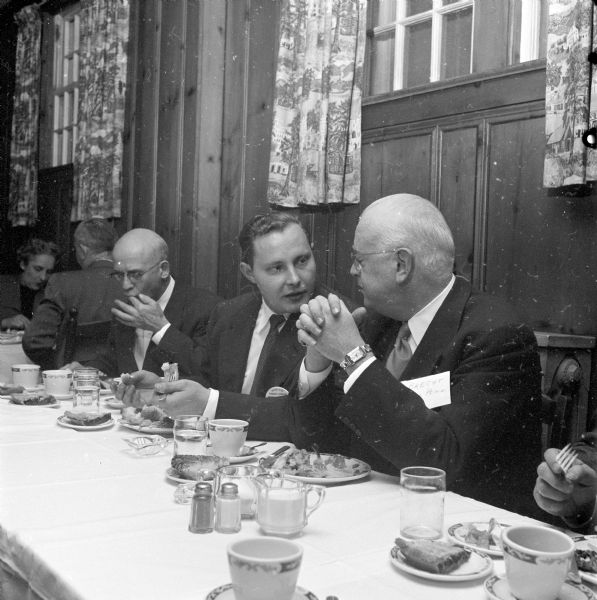 During a dinner meeting of the Madison Chapter of the association, Robert Bluell of the Findorf Co. (left), chats with Robert Brecht, University of Pennsylvania faculty. Brecht was the main speaker for the event.   