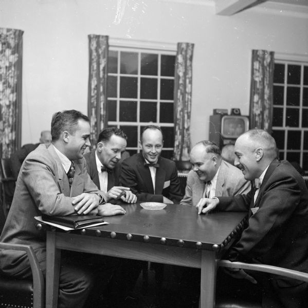 Discussion at a dinner program. From left to right are: Robert R. Larsen and T.W. Johnson from Marinette; Roy Lindberg, University of Wisconsin; M.S. Phoenix from Portland, Connecticut; and Earl Scheibe from Chicago.