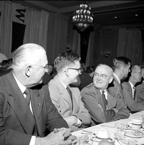 U.W. football fans,Tom Cullinan and William Cullinan (center), conversing after dinner.