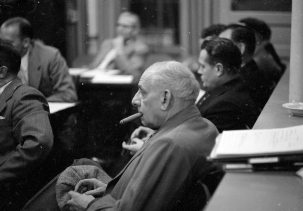 Spectators and members at the Madison City Council meeting on November 24,1953. A cigar-smoking man listens to the proceedings.