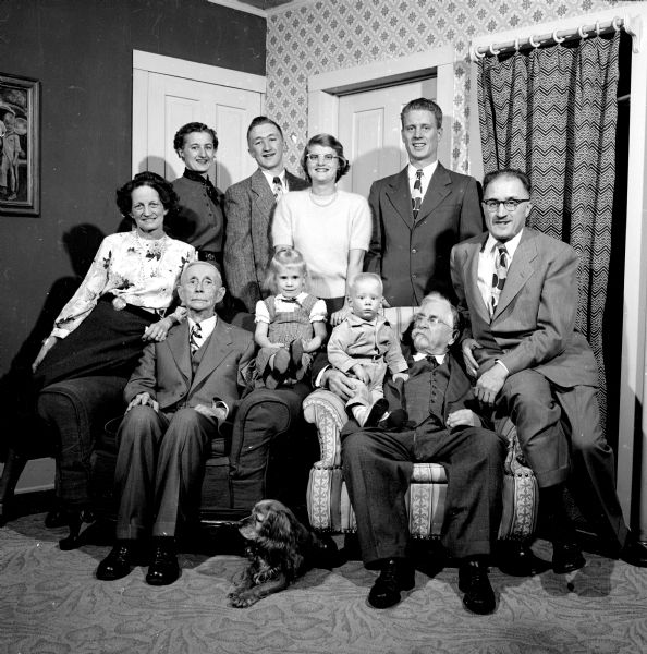 Ten members of the Russell Frost family, including a dog, gathered in a home.