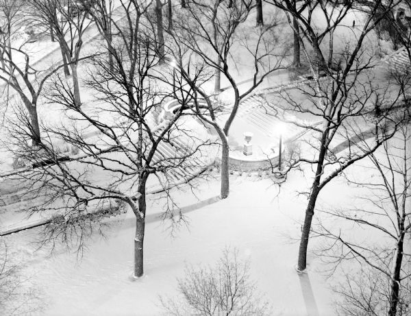Snowfall scene of the Wisconsin State Capitol steps leading to State Street, taken from an elevated view on North Carroll Street.