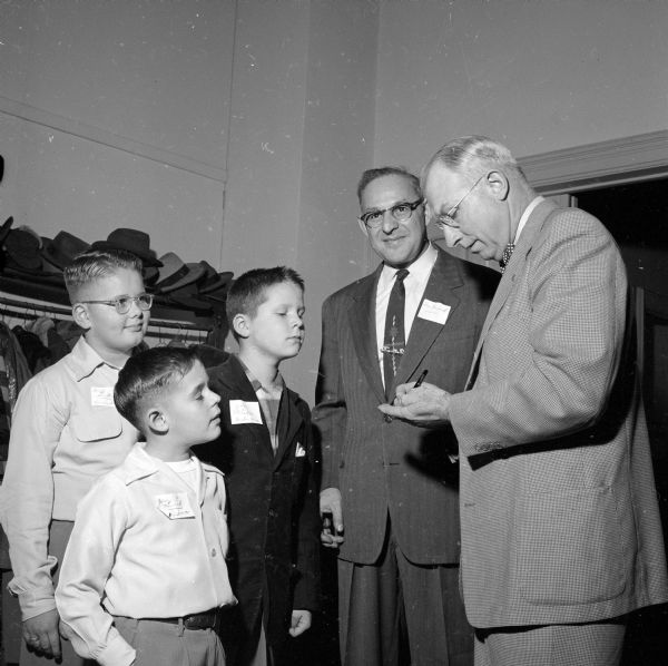 J. Frank Wilkinson signs autographs for Tom Novick and three boys at the annual father-son banquet at University Methodist Church.