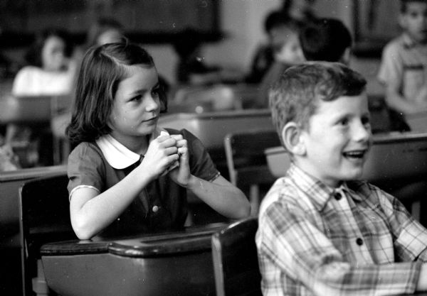 Members of the 4th-grade class viewing the scroll screen play, which they had produced. The play, "A Day in the Jungle," was planned and coordinated by their teacher, Beverly Everson. Intent on watching the production is student Diana Kellsh. The unnamed boy was cropped from the published photograph.