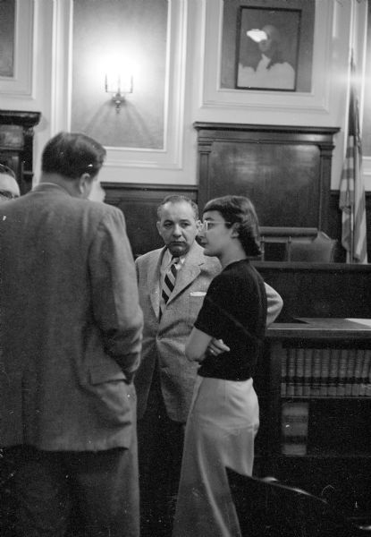 Diane Nelson, 20-year-old bookkeeper, is shown reviewing with her attorney, Maurice B. Pasch, the testimony she gave as the chief prosecution witness against Albert A. Hanson, 25, twice-married lover for whom she bore an illegitimate child and stole $12,215 from the Meuer Photoart House. Albert A. Hanson faces a possible prison term on charges of adultery and receiving stolen money. Albert pleaded guilty to charges of adultery with his former girlfriend, Diane Nelson.