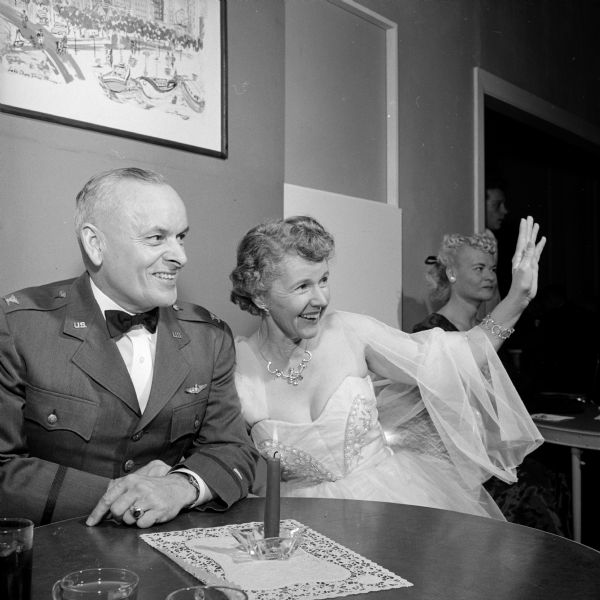 Guests at the Truax Field Officers Club formal "debt party" and dance celebrating the opening of the new clubhouse. Col. E.P. Archibald, commandant of the Air Force ROTC at the University of Wisconsin, with his wife Florence Archibald shown waving to new arrivals.