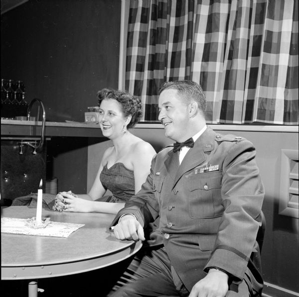 Guests at the Truax Field Officers Club formal "debt party" and dance celebrating the opening of the new clubhouse. Major  William I. Ryrom, director of material at Truax Field, and Mrs. Ryrom, president of the Truax Field Officers Wives Club.