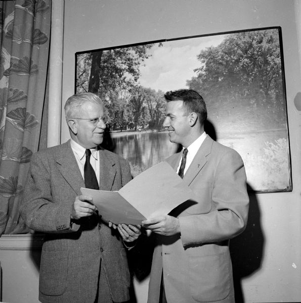 R.W. Bardwell and Jack Donis, two officials of the Dane County chapter of the National Foundation for Infantile Paralysis, confer at the Polio Kickoff Banquet.