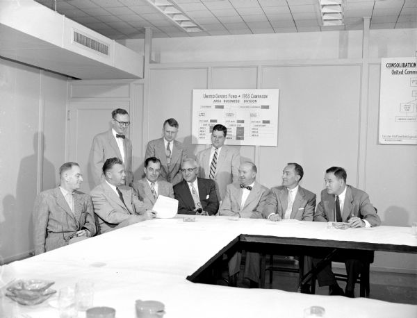 United Givers' Business and Industrial Employees Division meet with section chairmen. Standing left to right: Lynn Terry, Stanley O. Nettum, and Robert Holland. Seated left to right: John C. Mackin, W.T. Johnson, Ted Bloss, John R. Wrage (association chairman of the general campaign), William Murphy, Wes Holmquist, and Robert Anthony (division chairman). 
