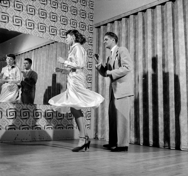Pauline Keyes and Jim Banta demonstrating a Latin dance step at the Arthur Murray dance studio.