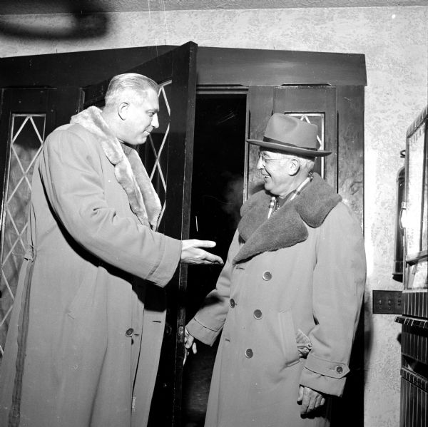 Freeman Fox greeting William D. Byrns, the first president of the West Side Business Men's Association, at the meeting to install 1954 officers at the Nakoma Golf Club. 