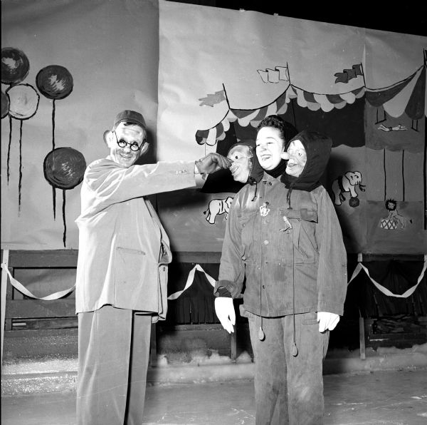 Members of the Madison Figure Skating Club held their annual winter party at the Truax Field Arena. The event was organized on a circus theme. Robert Beck and Dorothy Sinykin are having fun with their masks.