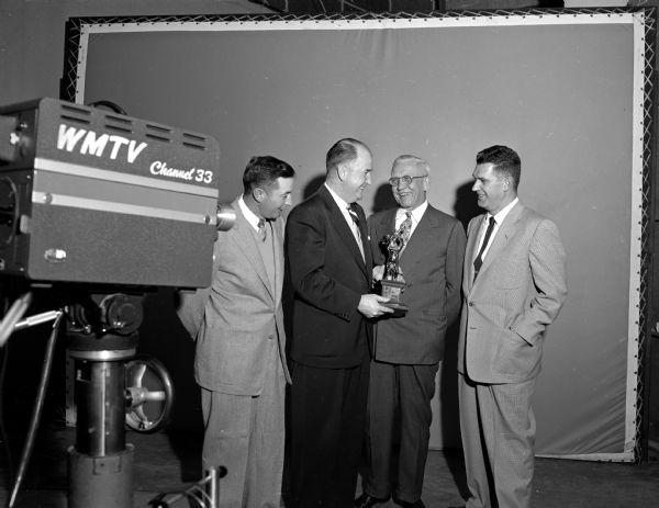 Four men and award at WMTV Channel 33.