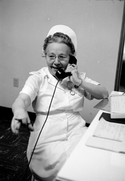 Nurse Loretta Heitkamp talking on the telephone at the Cuba City Hospital and Clinic.