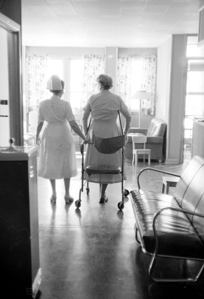 A nurse standing next to a patient who is exercising at the Cuba City Hospital and Clinic.