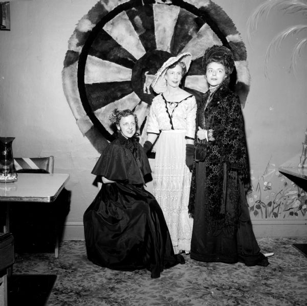 "Ads and Fads," Madison Advertising Club Women's Night, was held at the Hoffman House. Members are wearing fashions from the first half of the twentieth century. Commentary was by Mrs. Charlotte Peterson, and music was by Pat Selleger. Shown are (left to right): Charlotte Peterson, Marion Mills and Rosemary Kappelmuger.    