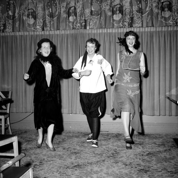 "Ads and Fads," Madison Advertising Club Women's Night, was held at the Hoffman House. Members are wearing fashions from the first half of the twentieth century, like flappers. Commentary was by Mrs. Charlotte Peterson, and music was by Pat Selleger. Shown are (left to right): Mrs. Lou Doyle, Lela Josephson and Doris Ardelt.