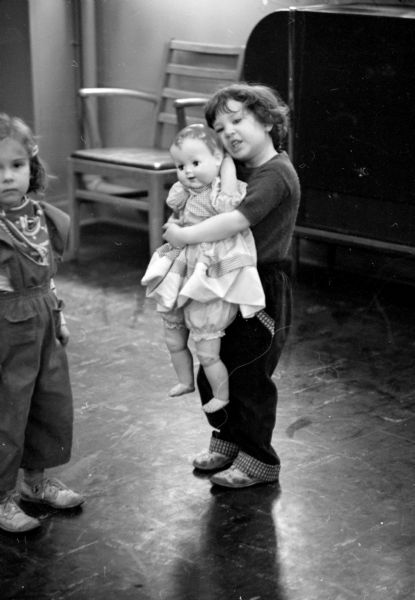 Bonnie Berman hugging a large doll.
