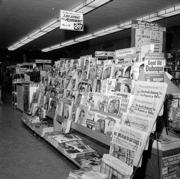 Magazine and newspaper rack at the Rennebohm Drug Store #16 at 2801 East Washington Avenue.