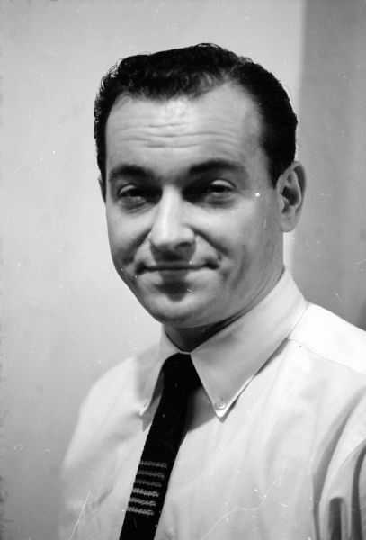 Quarter-length portrait of shoe salesman, Larry Borenstein, who worked in the family department store, Borenstein's Dry Goods Store, located in the Atwood neighborhood.