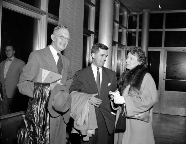 Visiting in the atrium of University of Wisconsin Union Theater prior to the performance of the musical comedy, "Wait and See," are (left to right): Professor Frank Thayer, Robert Narowetz, and Virginia Thayer. Narowetz' wife, Harriet, choreographed the show.