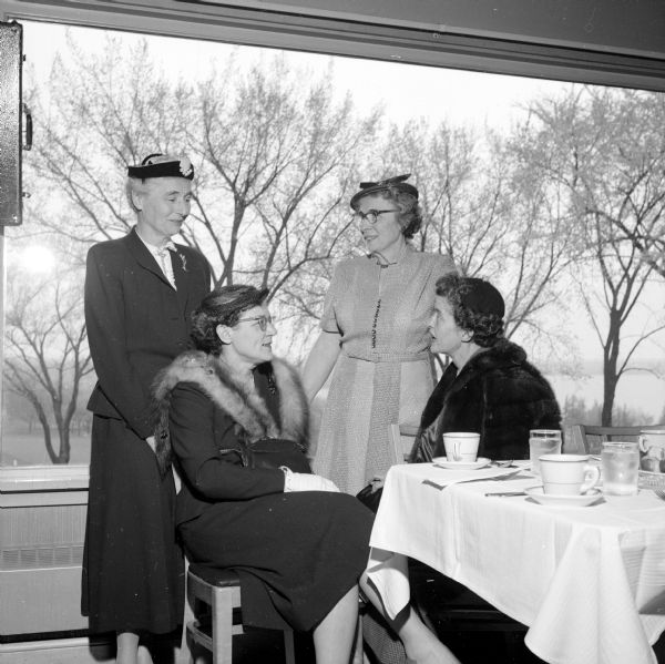 Annual Attic Angel Association, spring luncheon meeting held at the Blackhawk Country Club. Shown are members of the board of directors (left to right): Mrs. Theresa Reese, Mrs. Dean Adams, Mrs. E.H. Carpenter and Mrs. B.W. Huiskamp.