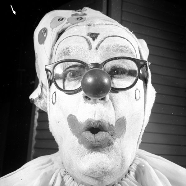 Zor Shrine clown J. Leigh's finished face with what would be a red nose. Leigh is also in full costume with hat and shirt.