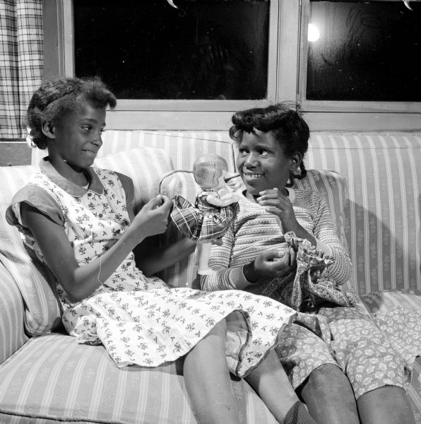 Margaret Rogers and Patricia Ann Johnson are chatting while working on doll dresses during a sewing class at Blessed Martin House.