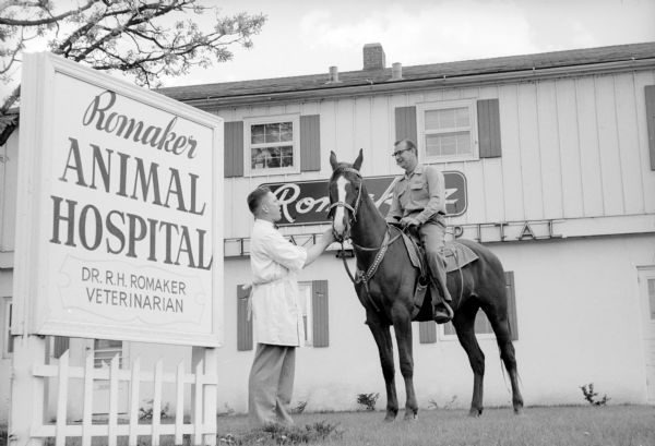 Ed Linden riding his horse "Big Red" to the front door of the Romaker Animal Hospital at 830 East Broadway Road to have veterinarian Dr. R.H. Romaker give the horse his regular checkup.