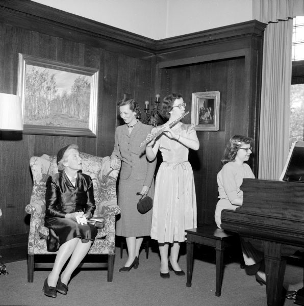 Beth Mitchell entertaining with a flute solo accompanied by Donna Ploog on piano as Mrs. Harold Kubly is listening to the music.